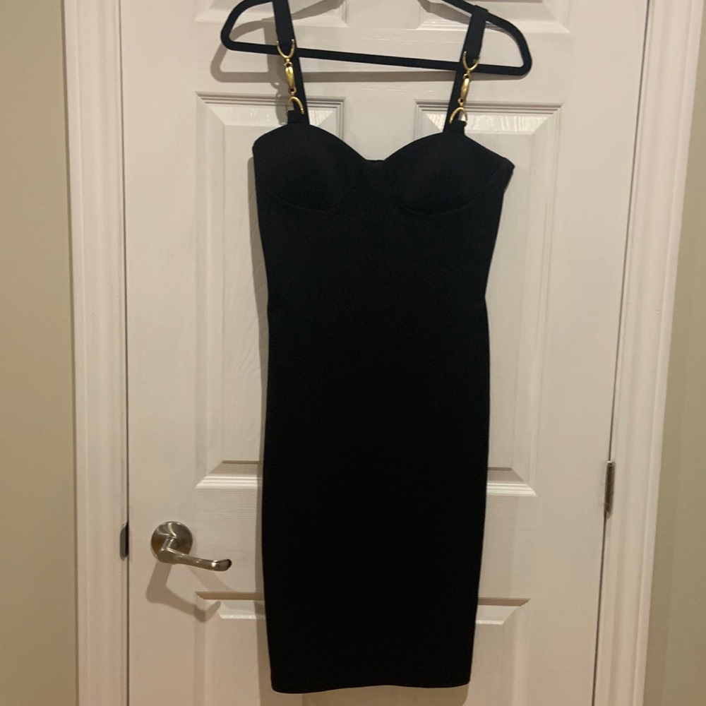 Sexy black dress. Gold hardware at straps. No zips. Just slip it on.